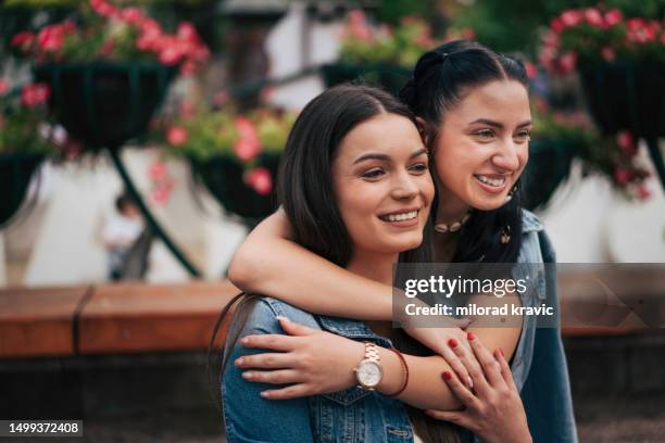 two girlfriends sitting in park. - tears of joy stock pictures, royalty-free photos & images