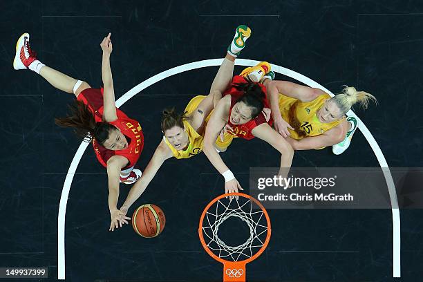 Belinda Snell of Australia shoots under pressure from Zengyu Ma of China and Xiaoli Chen of China while team mate Lauren Jackson of Australia watches...