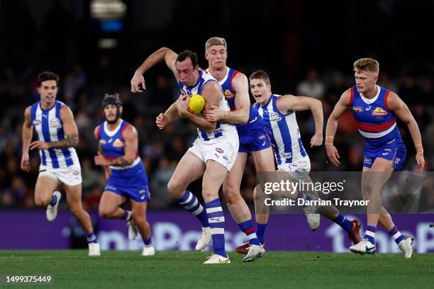 Tim English of the Bulldogs tackles Todd Goldstein of the Kangaroos during the round 14 AFL match between North Melbourne Kangaroos and Western...