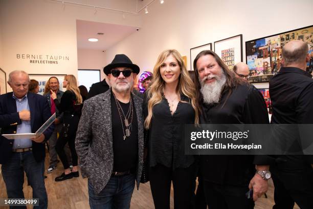 Bernie Taupin, Nicole Alessandrino and Kelly “Risk” Graval attend the opening of Bernie Taupin's art exhibit "Reflections" at Choice Contemporary on...