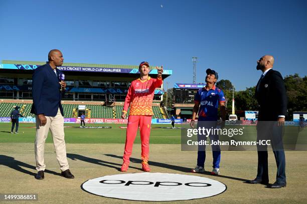 Craig Ervine of Zimbabwe tosses a coin as Rohit Paudel of Nepal looks on prior to the ICC Men's Cricket World Cup Qualifier Zimbabwe 2023 match...