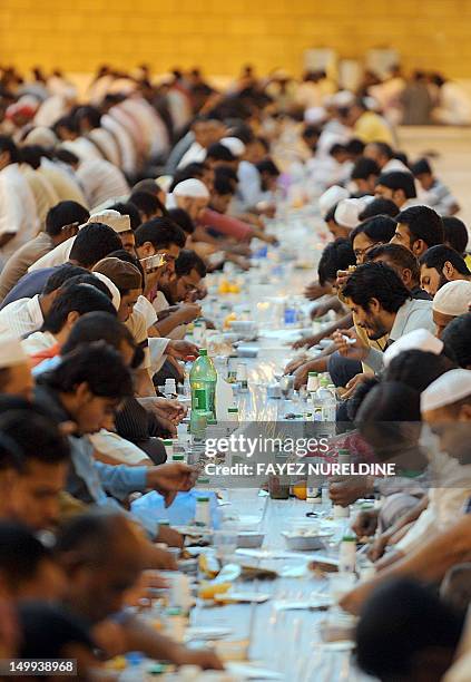 Foreign workers break their fast outside the Imam Turki bin Abdullah mosque in the Saudi capital Riyadh during Islam's holy month of Ramadan on...