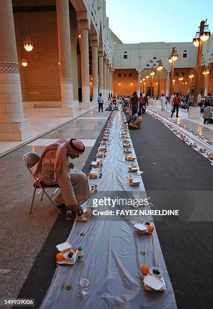 Man takes his place as foreign workers begin to arrive to break their fast outside the Imam Turki bin Abdullah mosque in the Saudi capital Riyadh...