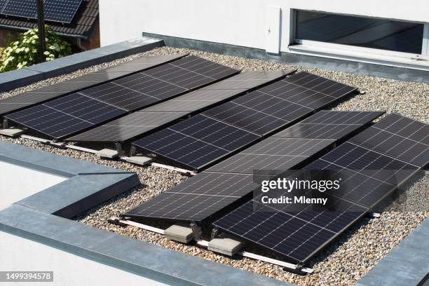 solar panels photovoltaic solar power on modern home sustainable energy - plat dak stockfoto's en -beelden