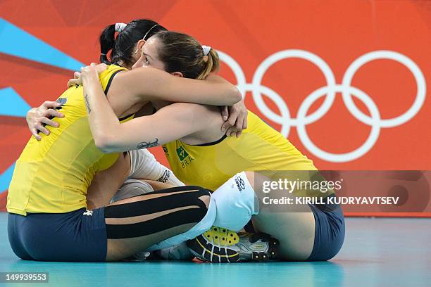 Brazil's Jaqueline Carvalho and Thaisa Menezes celebrate Brazil's victory in the Women's quarterfinal volleyball match between Russia and Brazil in...