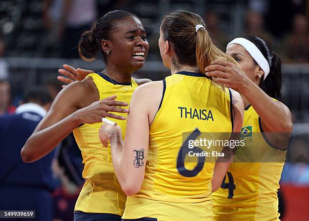 Fabiana Claudino, Thaisa Menezes and Paula Pequeno of Brazil celebrate the win over Russia during Women's Volleyball quarterfinals on Day 11 of the...