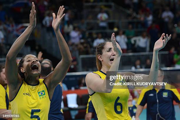 Brazil's Adenizia Silva and Thaisa Menezes celebrate Brazil's victory in the Women's quarterfinal volleyball match between Russia and Brazil in the...