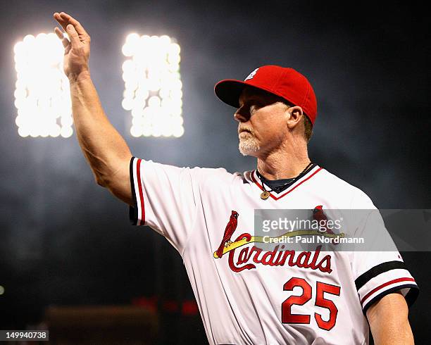 Hitting coach Mark McGwire of the St. Louis Cardinals waves to fans after a game against the Milwaukee Brewers at Busch Stadium on August 4, 2012 in...