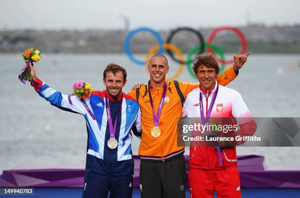 Gold medallist Dorian Van Rijsselberge of Netherlands celebrates with silver medallist Nick Dempsey of Great Britain and bronze medallist Przemyslaw...