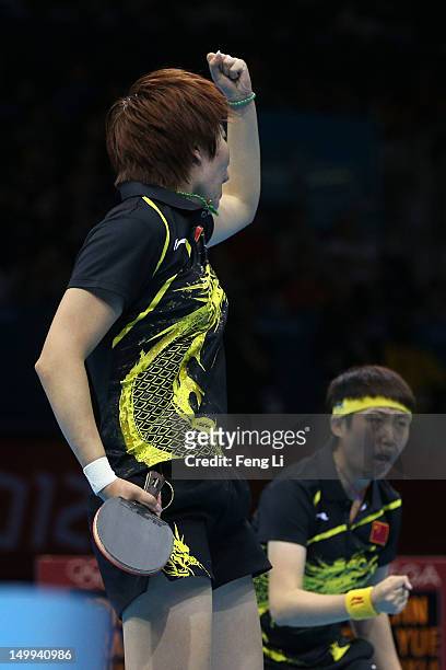 Yue Guo and Xiaoxia Li of China celebrate against Kasumi Ishikawa and Sayaka Hirano of Japan during the Women's Team Table Tennis gold medal match on...
