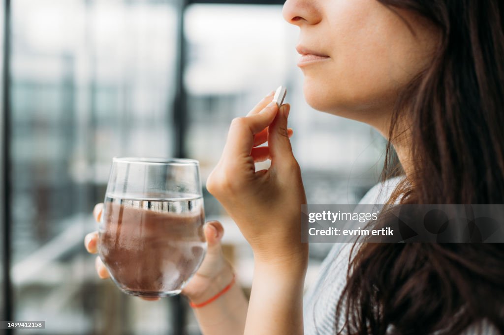 Woman taking pill for getting better
