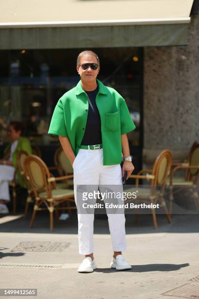 Guest wears black aviator sunglasses, a black t-shirt, a flashy green embossed mesh pattern short sleeves buttoned jacket, a flashy green with silver...