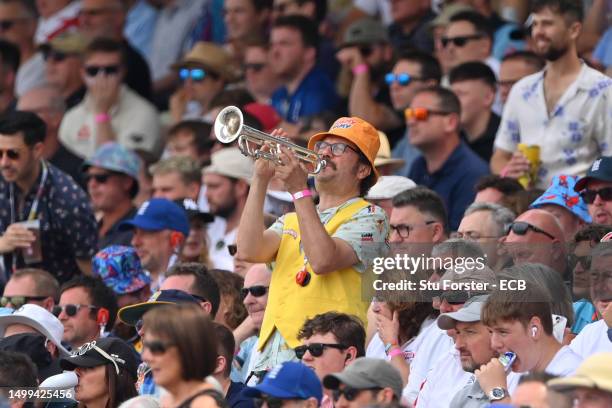 An England fan from the barmy army plays a trumpet during Day Three of the LV= Insurance Ashes 1st Test match between England and Australia at...