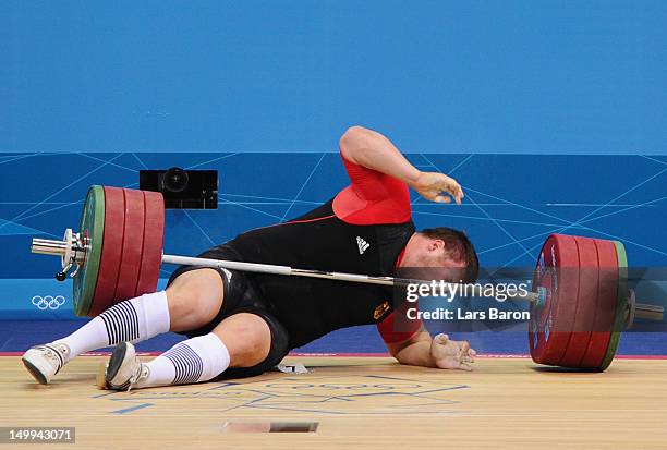 Matthias Steiner of Germany lies on the floor after failing to lift in the Men's +105kg Weightlifting final on Day 11 of the London 2012 Olympic...