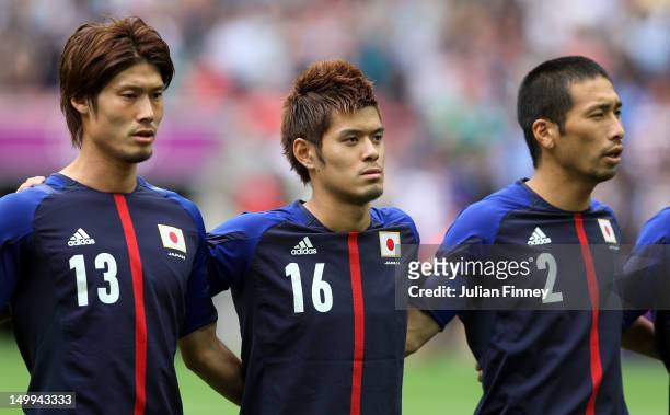 Daisuke Suzuki of Japan, Hotaru Yamaguchi of Japan and Yuhei Tokunaga of Japan look on during the Men's Football Semi Final match between Mexico and...