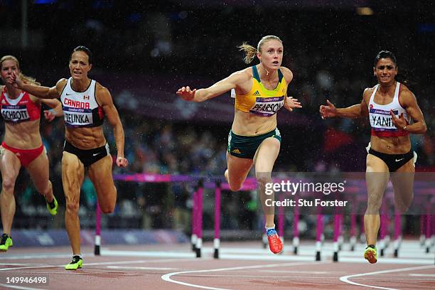 Sally Pearson of Australia leads Phylicia George of Canada and Nevin Yanit of Turkey during the Women's 100m Hurdles Final on Day 11 of the London...