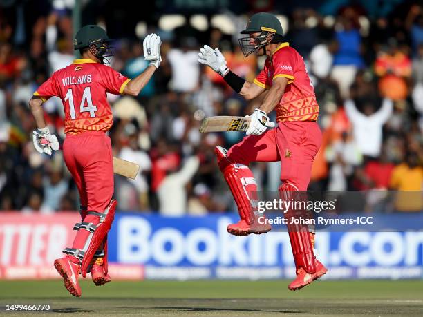 Craig Ervine of Zimbabwe celebrates reaching their century with teammate Sean Williams during the ICC Men's Cricket World Cup Qualifier Zimbabwe 2023...