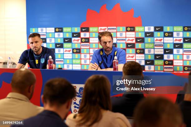 Luke Shaw of England and Gareth Southgate, Manager of England, speak to the media during a press conference at Carrington Training Ground on June 18,...