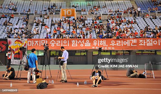 South Korean suppoters watch on a giant screen the London 2012 Olympic Games men's football semifinal match between South Korea and Brazil in...