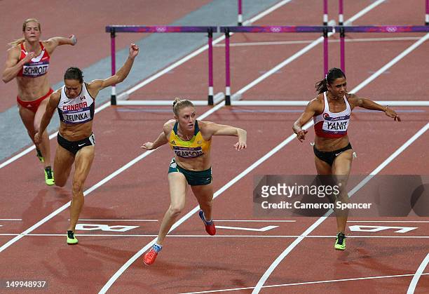 Sally Pearson of Australia crosses the finish line ahead of Jessica Zelinka of Canada and Nevin Yanit of Turkey to win gold in the Women's 100m...
