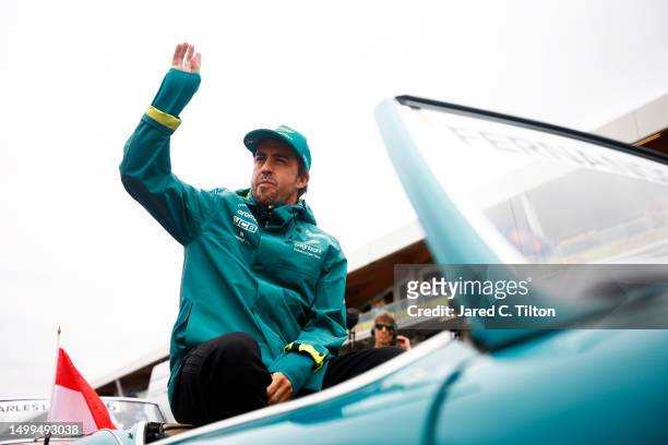 Fernando Alonso of Spain and Aston Martin F1 Team waves to the crowd on the drivers parade prior to the F1 Grand Prix of Canada at Circuit Gilles...