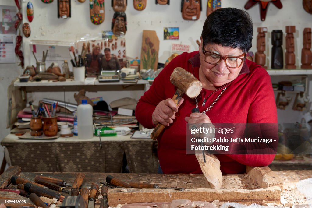 Senior adult carving wood