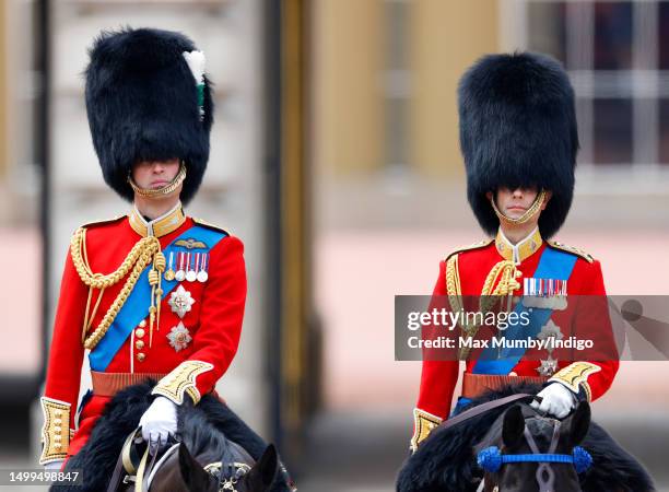 Prince William, Prince of Wales and Prince Edward, Duke of Edinburgh watch a march past outside Buckingham Palace after attending Trooping the Colour...