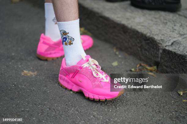 Guest wears white with orange and blue duck print pattern socks, neon pink fabric sneakers from Nike , outside Emporio Armani, during the Milan...