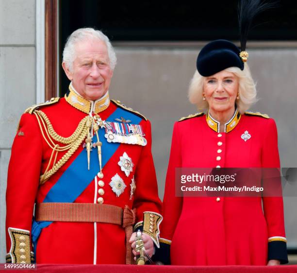 King Charles III and Queen Camilla watch an RAF flypast from the balcony of Buckingham Palace during Trooping the Colour on June 17, 2023 in London,...