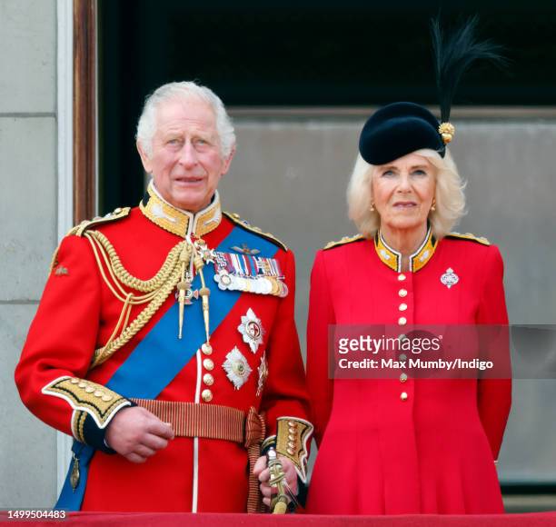 King Charles III and Queen Camilla watch an RAF flypast from the balcony of Buckingham Palace during Trooping the Colour on June 17, 2023 in London,...