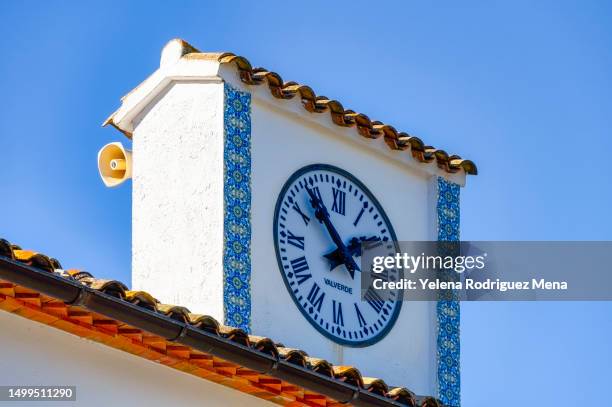 clock in town square in guadalest - spanish-colonial-architecture stock pictures, royalty-free photos & images