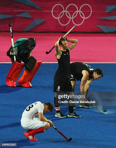 Goal keeper Kyle Pontifex of New Zealand and team mates captain Dean Couzins and Nicholas Haig show their emotions at the end of the match during the...
