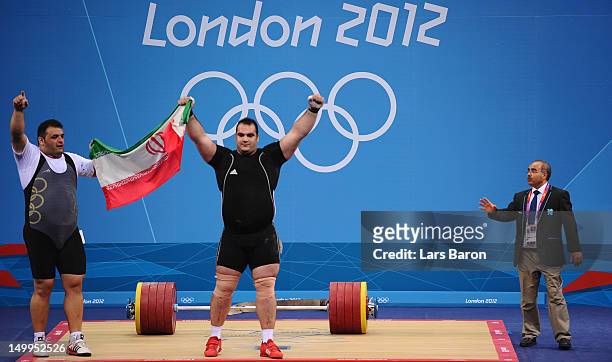 Behdad Salimikordasiabi of Iran celebrates winning the gold medal while Sajjad Anoushiravani Hamlabad of Iran celebrates winning the silver medal in...