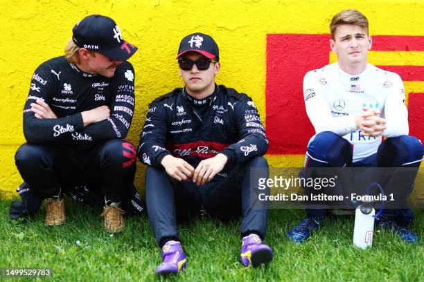 Valtteri Bottas of Finland and Alfa Romeo F1, Zhou Guanyu of China and Alfa Romeo F1and Logan Sargeant of United States and Williams look on, on the...