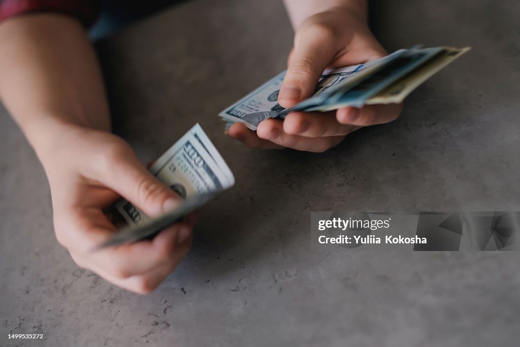 Hand with money. Saving money concept. Man offering batch of hundred dollar bills. Venality, bribe, corruption concept.
