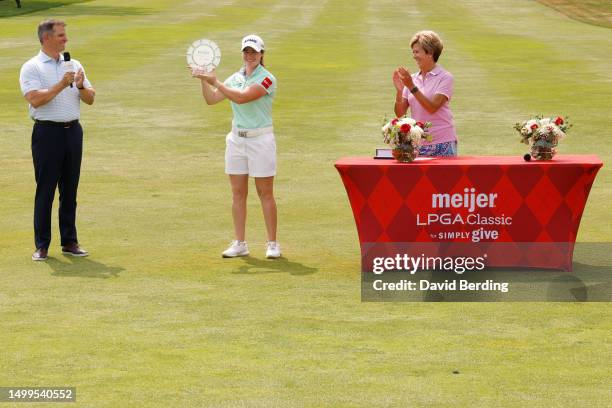 Leona Maguire of Ireland is awarded the trophy by Meijer President and CEO Rick Keyes and Tournament Executive Director Cathy Cooper after winning...