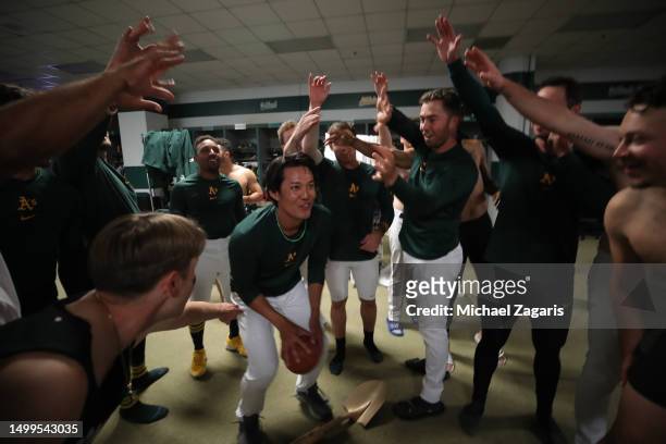 Shintaro Fujinami of the Oakland Athletics takes a celebration shot in the clubhouse after the game against the Atlanta Braves at RingCentral...