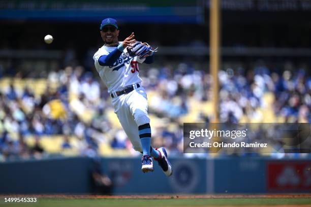 Mookie Betts of the Los Angeles Dodgers throws to first base on a ground out by Michael Conforto of the San Francisco Giants during the first inning...