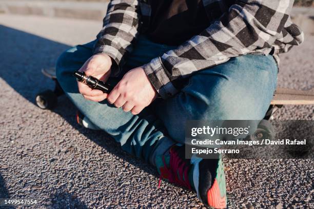 close-up of a modern man holding a vaper - shisha smoke stock pictures, royalty-free photos & images