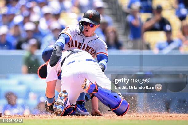 Joc Pederson of the San Francisco Giants collides with Will Smith of the Los Angeles Dodgers while scoring a run during the fourth inning at Dodger...