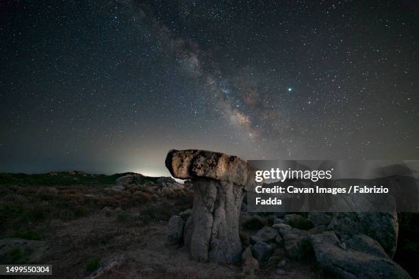 milky way panorama above a mushroom-shaped rock - rocky star stock pictures, royalty-free photos & images