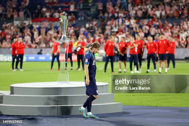 Luka Modric of Croatia walks past the UEFA Nations League trophy with their runners up medal after the team's defeat during the UEFA Nations League...
