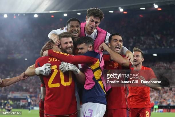 Unai Simon of Spain is mobbed by team mates after victory in the UEFA Nations League 2022/23 final match between Croatia and Spain at De Kuip on June...