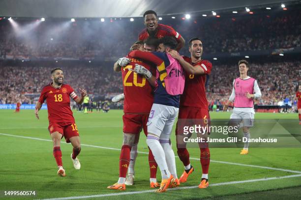 Unai Simon of Spain is mobbed by team mates after victory in the UEFA Nations League 2022/23 final match between Croatia and Spain at De Kuip on June...