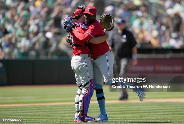 Realmuto and Yunior Marte of the Philadelphia Phillies celebrates defeating the Oakland Athletics 3-2 at RingCentral Coliseum on June 18, 2023 in...