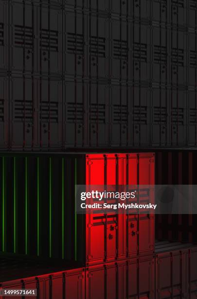 close-up of shipping container warehouse in red neon light at night. - shipping containers green red stock-fotos und bilder