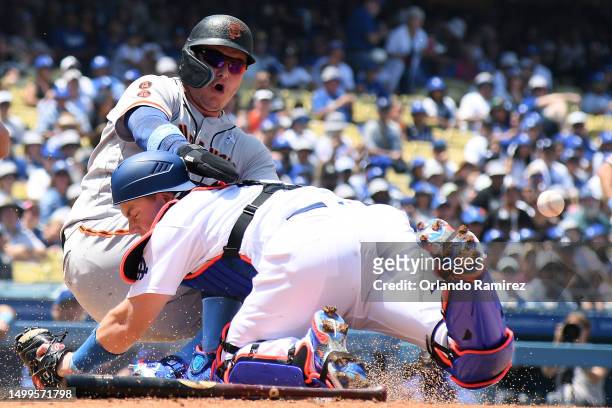 Joc Pederson of the San Francisco Giants collides with Will Smith of the Los Angeles Dodgers while scoring a run during the fourth inning at Dodger...