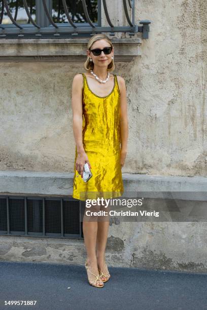 Jenny Walton wears yellow golden dress outside Prada during the Milan Fashion Week - Menswear Spring/Summer 2024 on June 18, 2023 in Milan, Italy.