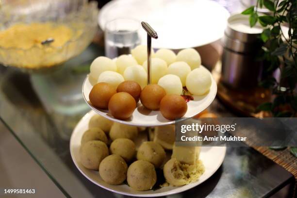 round shape sweets (mithai) arranged on sweet stand. - mithai stock pictures, royalty-free photos & images