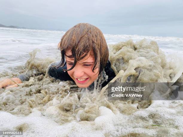 tween playing in the surf and waves during summer break - miss world stock pictures, royalty-free photos & images